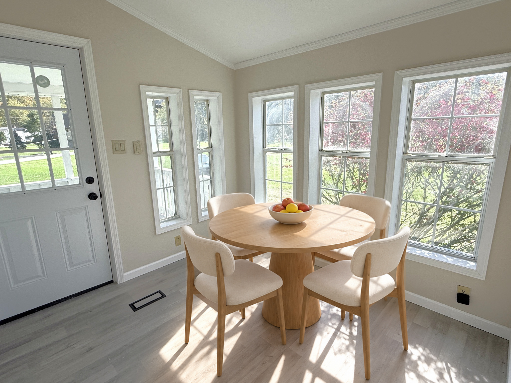 Window-lined dining area at 120 Blythe Road, virtually staged.